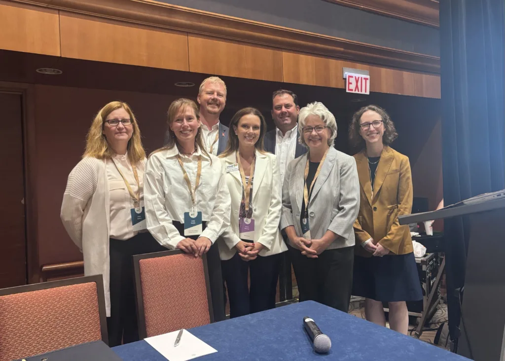 Image of the seven panelists after concluding the event.